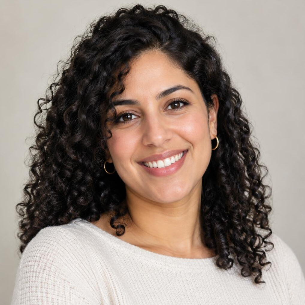 Portrait of a young woman with curly hair smiling